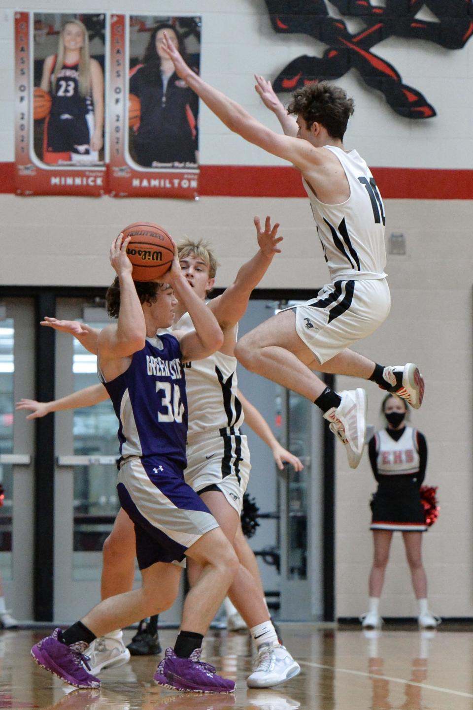 Edgewood’s Coleman Sater (5) and Caden Huttenlocker (in air) double-team Greencastle’s Nick Sutherlin (30) during their boys' basketball game in Ellettsville in December of 2020.