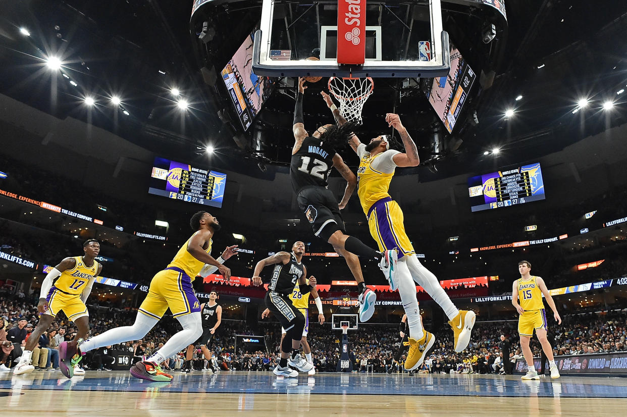 MEMPHIS, TENNESSEE - FEBRUARY 28: Ja Morant #12 of the Memphis Grizzlies goes to the basket against Anthony Davis #3 of the Los Angeles Lakers during the game at FedExForum on February 28, 2023 in Memphis, Tennessee. NOTE TO USER: User expressly acknowledges and agrees that, by downloading and or using this photograph, User is consenting to the terms and conditions of the Getty Images License Agreement. (Photo by Justin Ford/Getty Images)
