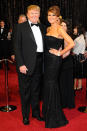 <p>In 2011, Melania wore a simple black strapless gown and a chic side-parted updo to the 83rd Academy Awards. (Photo: Getty Images) </p>