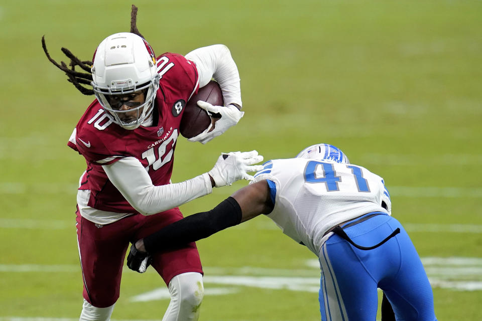 Arizona Cardinals wide receiver DeAndre Hopkins (10) eludes the grasp of Detroit Lions cornerback Chris Jones (41) during the second half of an NFL football game, Sunday, Sept. 27, 2020, in Glendale, Ariz. (AP Photo/Ross D. Franklin)