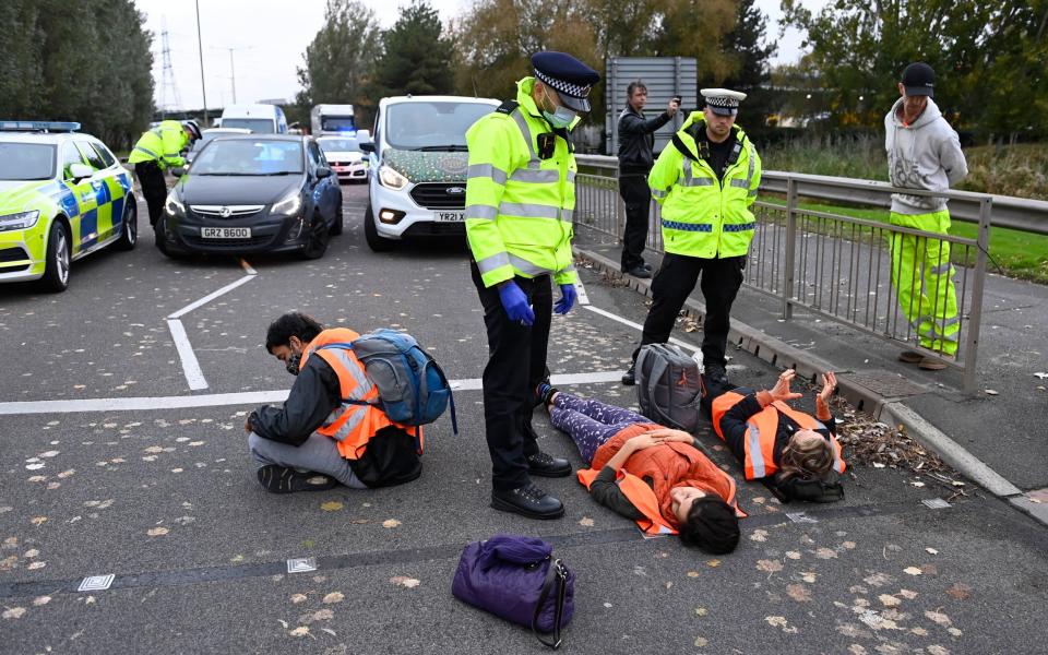 Protesters lying down in the road in Dartford - Steve Finn for The Telegraph