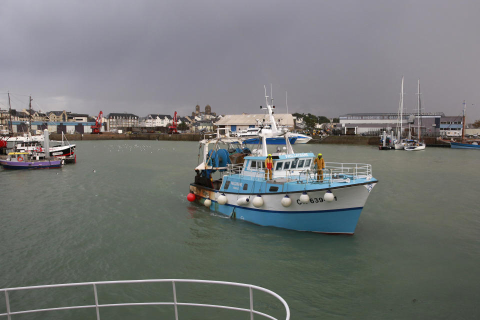 A French trawler coming from the British waters arrives at the port of Granville, Normandy, Monday, Nov. 1, 2021. France has threatened to bar British boats from some of its ports and tighten checks on boats and trucks carrying British goods if more French vessels aren't licensed to fish in U.K. waters by Tuesday Oct.2, 2021. French fishing crews stood their ground, demanding a political solution to a local dispute that has become the latest battleground between Britain and the European Union. (AP Photo/Nicolas Garriga)