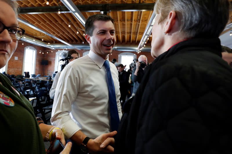 FILE PHOTO: Democratic 2020 U.S. presidential candidate and former South Bend Mayor Pete Buttigieg shakes hands with a supporter after a campaign town hall meeting in Newton, Iowa