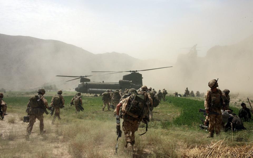 British Paratroopers board a Chinook helicopter to return to their base after they detained some Taliban leaders in the village of Segera, Kandahar Province  - Marco Di Lauro /Getty Images 