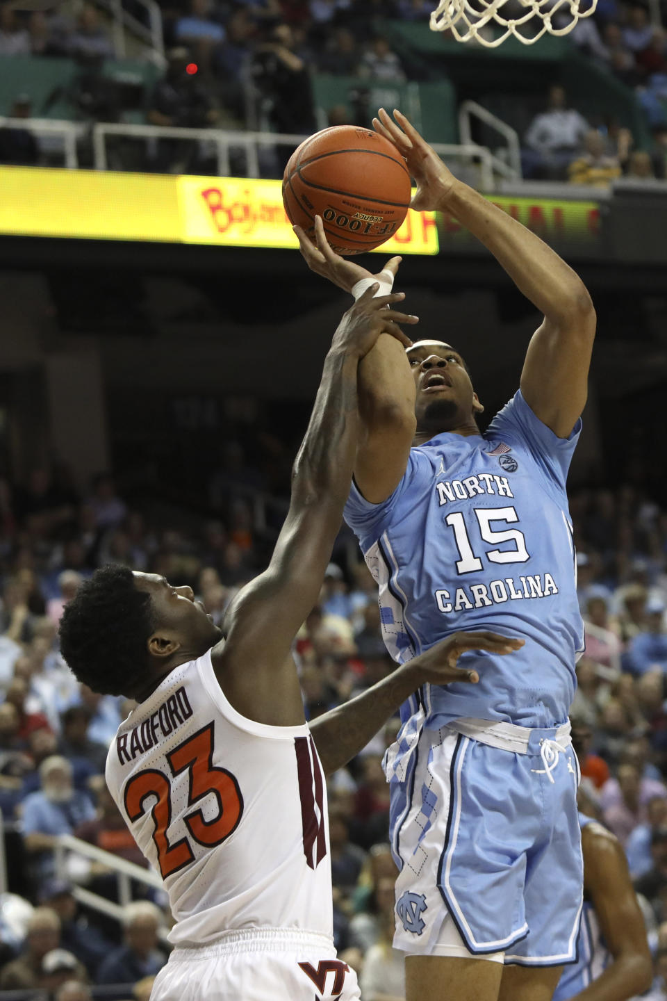 Virginia Tech guard Tyrece Radford (23) defends while North Carolina forward Garrison Brooks (15) shoots during the first half of an NCAA college basketball game at the Atlantic Coast Conference tournament in Greensboro, N.C., Tuesday, March 10, 2020. (AP Photo/Ben McKeown)