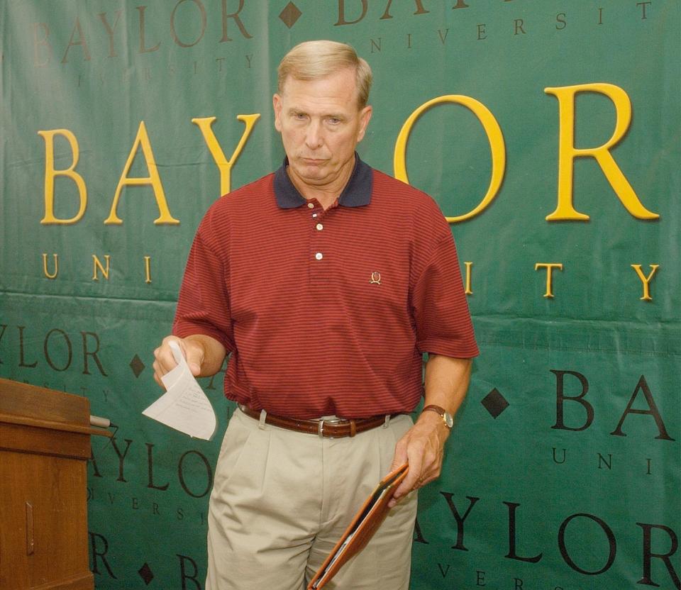 Dave Bliss collects his notes after announcing his resignation as Baylor coach on Aug. 8, 2003.