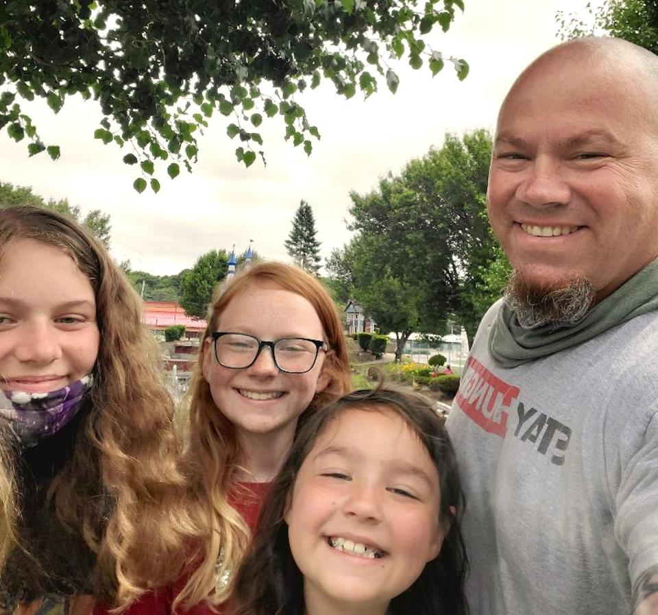 Softball coach Brian Goodhart with his three daughters, Jacey, Aundrea and Chloe.