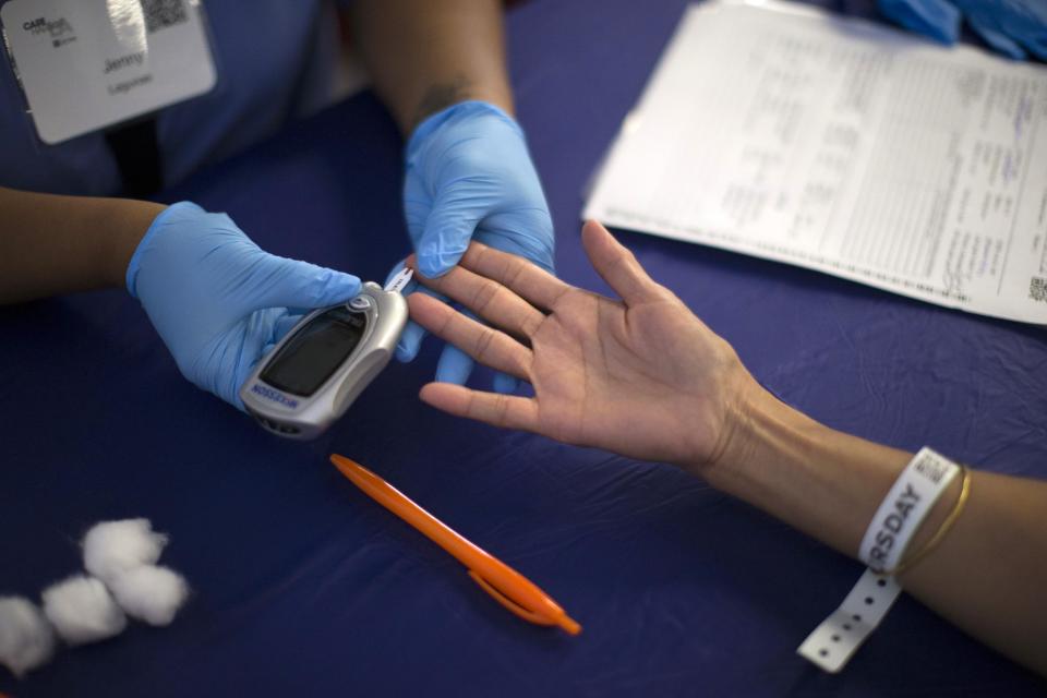 A person receives a test for diabetes during Care Harbor LA free medical clinic September 11, 2014. (Reuters)