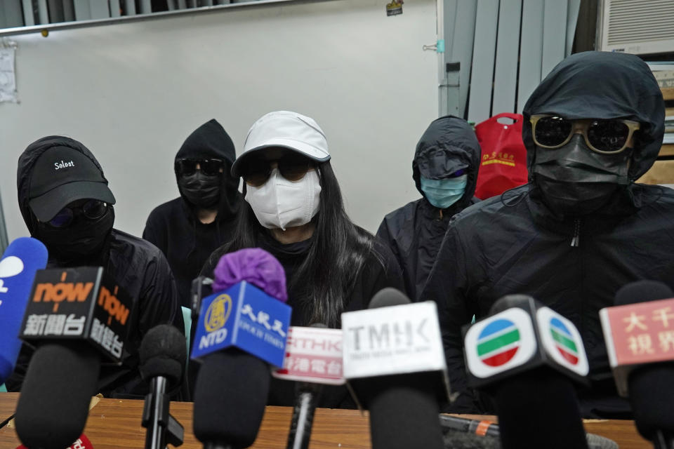 Relatives of 12 Hong Kong activists detained at sea by Chinese authorities, attend a press conference in Hong Kong, Monday, Dec. 28, 2020. Trials for 10 people accused of attempting to flee Hong Kong by speedboat amid a government crackdown on dissent got underway in China on Monday, a court official said. The defendants face charges of illegally crossing the border, while two face additional charges of organizing the attempt, according to an indictment issued in the southern city of Shenzhen. (AP Photo/Kin Cheung)