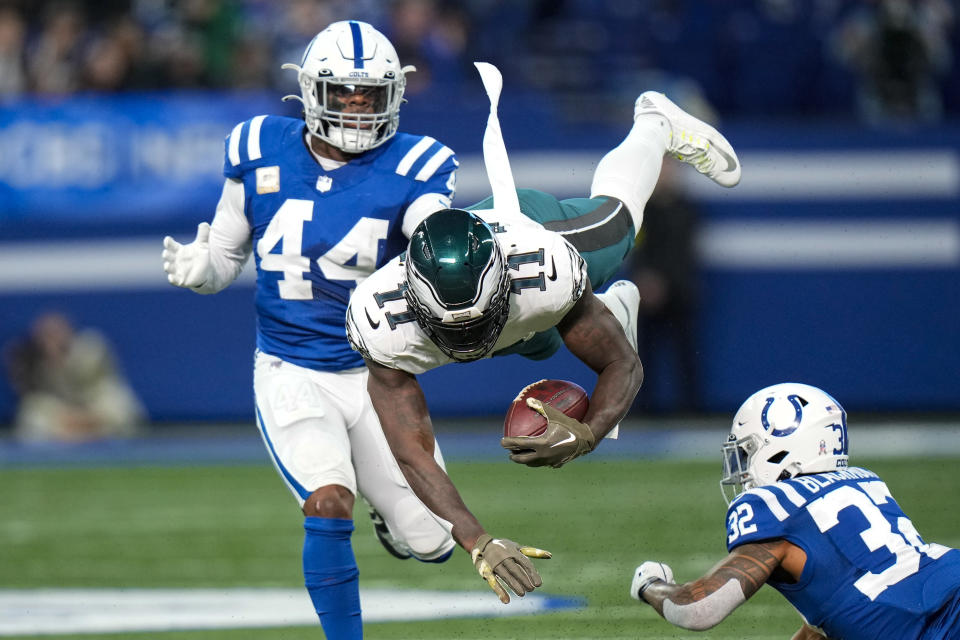 Philadelphia Eagles wide receiver A.J. Brown (11) dives between Indianapolis Colts linebacker Zaire Franklin (44) and safety Julian Blackmon (32) in the first half of an NFL football game in Indianapolis, Sunday, Nov. 20, 2022. Pass interference negated the play. (AP Photo/AJ Mast)