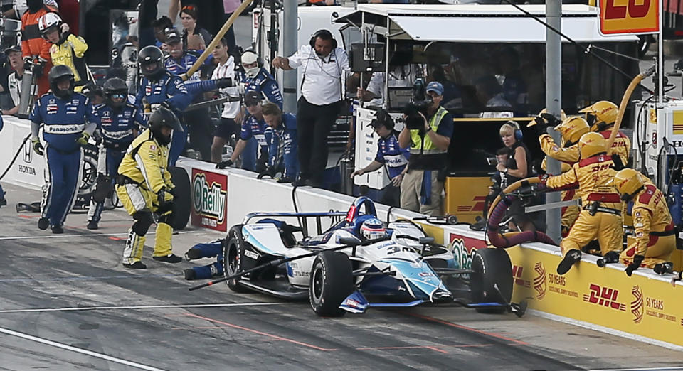 Takuma Sato collides with a member of his pit crew, knocking him to the ground, during the IndyCar auto race at Texas Motor Speedway, Saturday, June 8, 2019, in Fort Worth, Texas. (AP Photo/Brandon Wade)