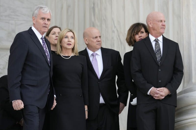 From left to right, Scott O'Connor, Jay O'Connor and Brian O'Connor, sons of retired Supreme Court Justice Sandra Day O'Connor, await the arrival of their mother's flag-draped casket at the Supreme Court in Washington on Monday. Pool Photo by Alex Brandon/UPI