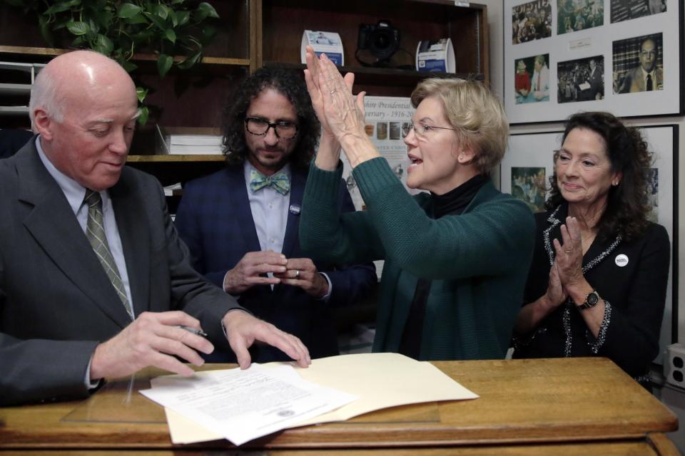 Democratic presidential candidate Sen. Elizabeth Warren, D-Mass., applauds after filing to have her name listed on the New Hampshire primary ballot, Wednesday, Nov. 13, 2019, in Concord, N.H. At left is New Hampshire Secretary of State Bill Gardner. (AP Photo/Charles Krupa)