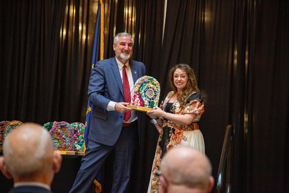 Christy Burgess, the director of the Notre Dame Shakespeare Festival Community Company, accepts the Governor's Arts Award from Gov. Eric Holcomb on Feb. 27, 2024. She is also the co-founder and Shakespeare Outreach Director for the Robinson Shakespeare Company (RSC) at the Robinson Community Learning Center.