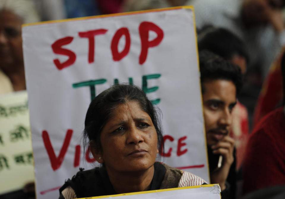 Activists from different organizations hold banners calling for peace and communal harmony following violence in New Delhi, India, Wednesday, Feb. 26, 2020. At least 20 people were killed and 189 injured in three days of clashes in New Delhi that coincided with U.S. President Donald Trump's first state visit to India, with the death toll expected to rise as hospitals continue to take in the wounded, authorities said Wednesday. (AP Photo/Rajesh Kumar Singh)