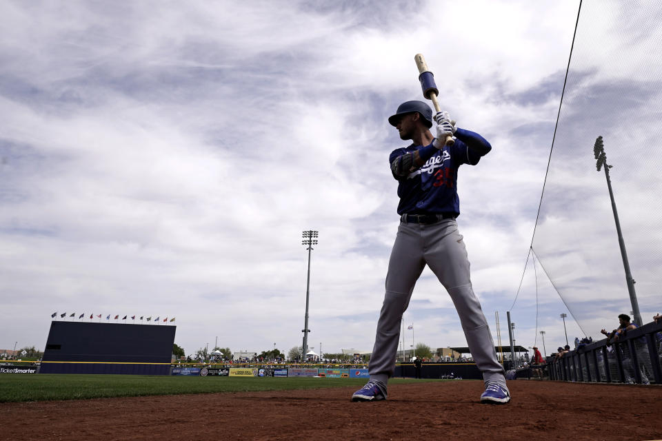 Los Angeles Dodgers' Cody Bellinger gets ready to bat before a spring training baseball game against the Seattle Mariners Saturday, March 19, 2022, in Peoria, Ariz. (AP Photo/Charlie Riedel)