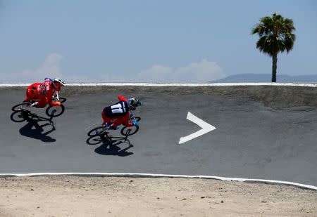 U.S. Olympic athlete Connor Fields (R) powers through a turn while training with New Zealand athlete Trent Jones at the Olympic Training Center in Chula Vista, California, United States, July 1, 2016. REUTERS/Mike Blake