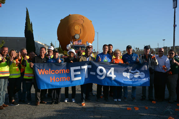 Helping to "Welcome Home ET-94" to the California Science Center were center president Jeffrey Rudolph (in blue, at center right); Lynda Oschin (in orange, at right of Rudolph), the wife of the late