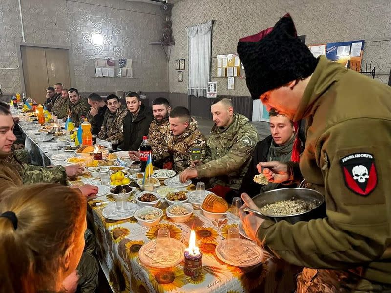 Ukrainian service members have their festive Christmas dinner at an unknown location in Ukraine