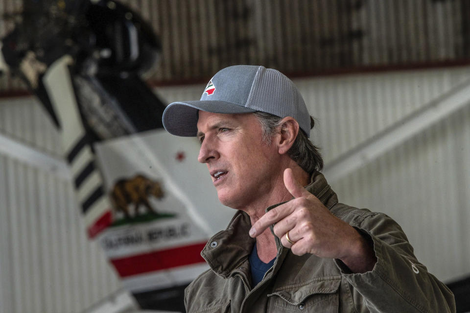 California Gov. Gavin Newsom highlights new firefighting equipment and his proposed $2 billion investment in wildfire and emergency preparedness at a press conference at Cal Fire's airbase in McClellan Park in Sacramento County on Monday, May 24, 2021. (Renee C. Byer/The Sacramento Bee via AP)