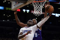 Los Angeles Clippers guard Reggie Jackson (1) shoots against Los Angeles Lakers center Dwight Howard (39) during the first half of an NBA basketball game in Los Angeles, Friday, Dec. 3, 2021. (AP Photo/Ashley Landis)