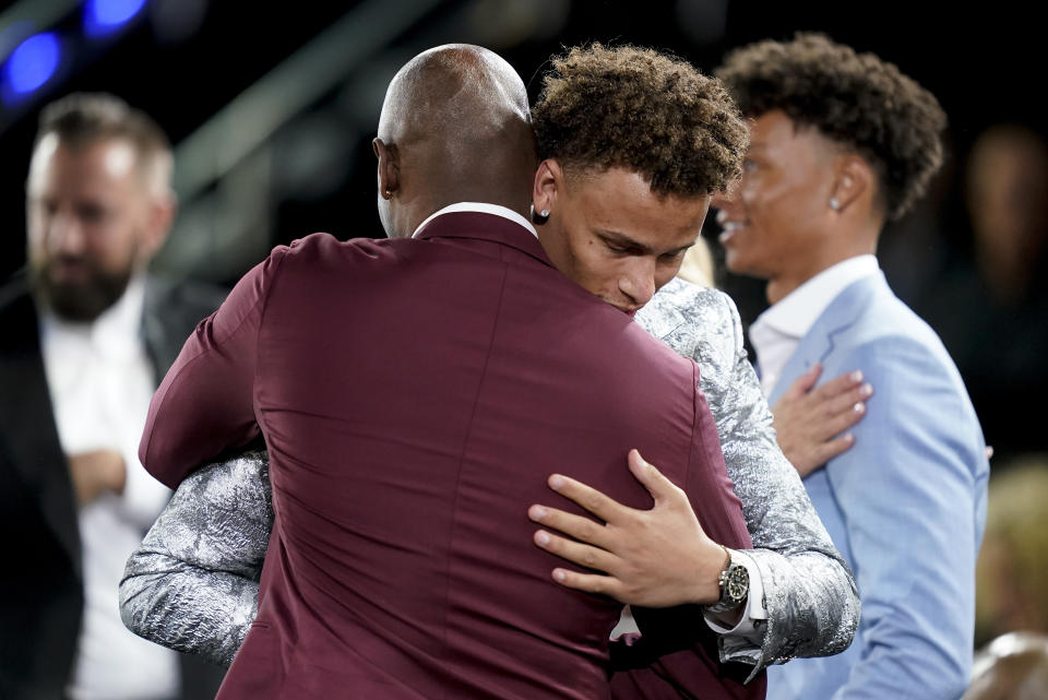 Dyson Daniels is congratulated by family and friends after being selected eighth overall by the New Orleans Pelicans in the NBA basketball draft, Thursday, June 23, 2022, in New York. (AP Photo/John Minchillo)