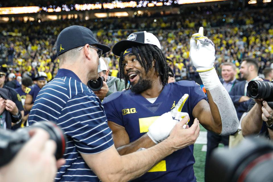 Michigan head coach Jim Harbaugh celebrates with running back Donovan Edwards (7) after winning the Big Ten Championship Lucas Oil Stadium in Indianapolis, Ind., on Saturday, Dec. 3, 2022.