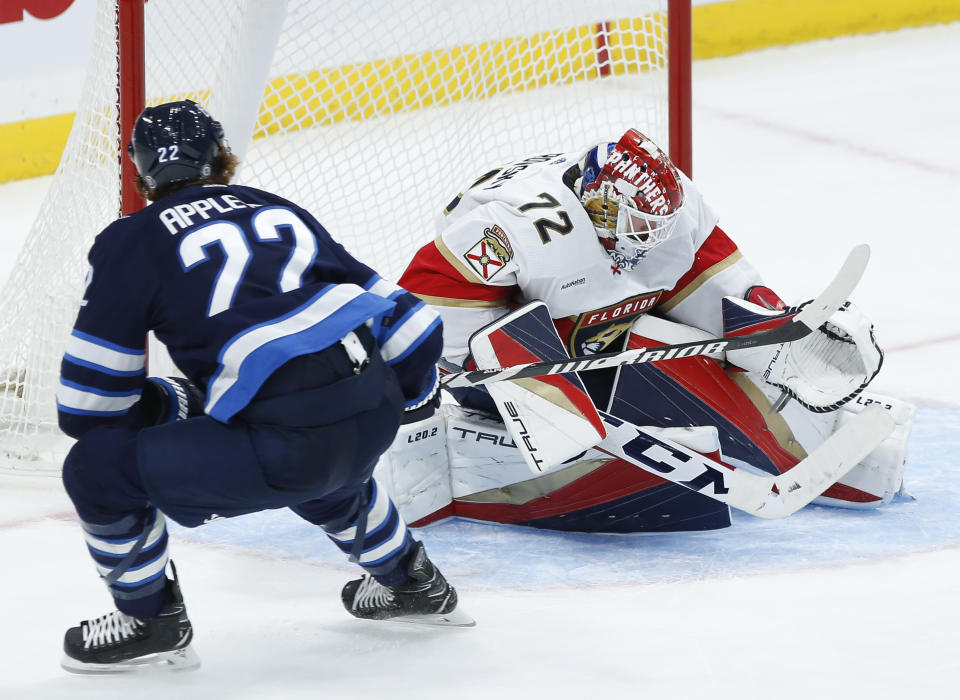 Winnipeg Jets' Mason Appleton (22) scores against Florida Panthers goaltender Sergei Bobrovsky (72) during third-period NHL hockey game action in Winnipeg, Manitoba, Saturday, Oct. 14, 2023. (John Woods/The Canadian Press via AP)