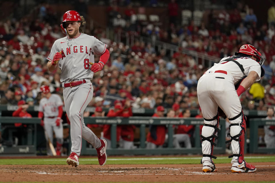 Los Angeles Angels' Brett Phillips (8) scores past St. Louis Cardinals catcher Andrew Knizner during the sixth inning of a baseball game Tuesday, May 2, 2023, in St. Louis. (AP Photo/Jeff Roberson)