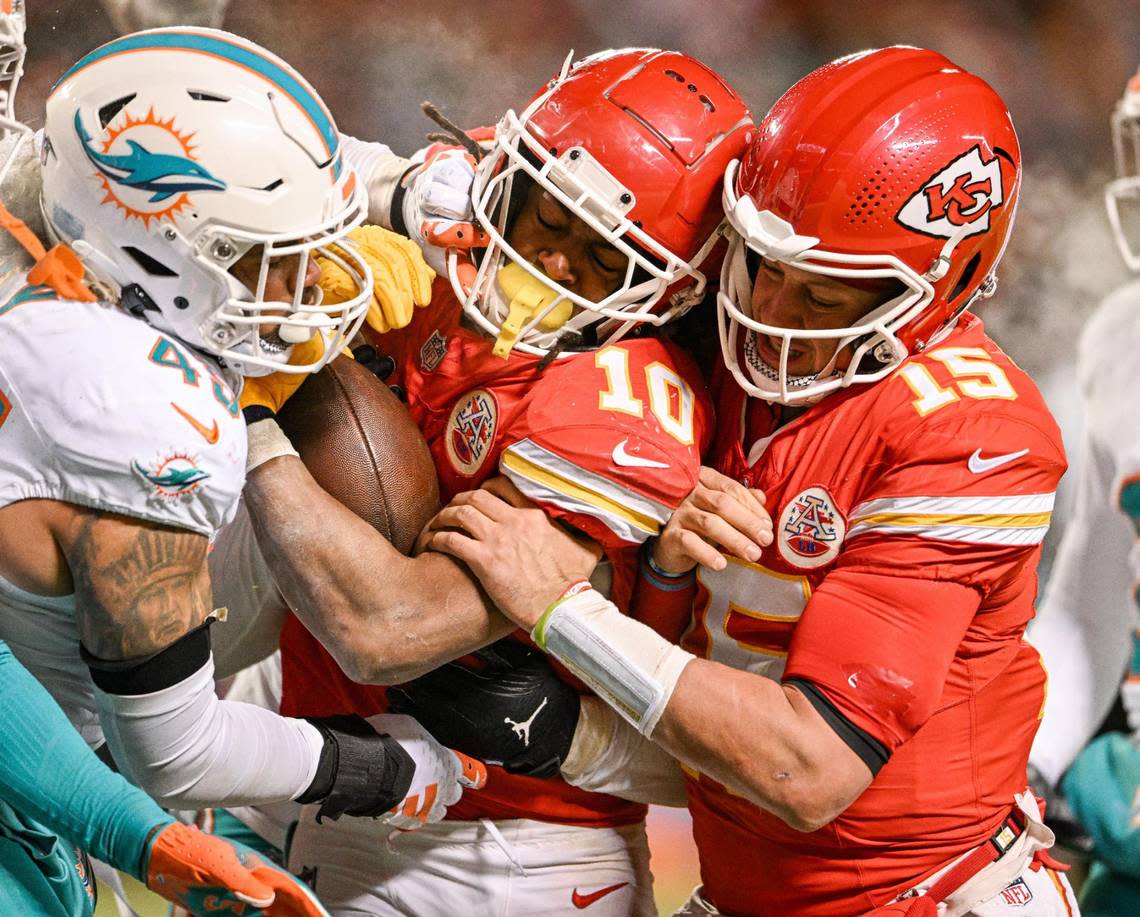 Kansas City Chiefs quarterback Patrick Mahomes (15) gives running back Isiah Pacheco (10) a shove to get him into the end zone for a touchdown in the fourth quarter against the Miami Dolphins Saturday, Jan. 13, 2024, at GEHA Field at Arrowhead Stadium.