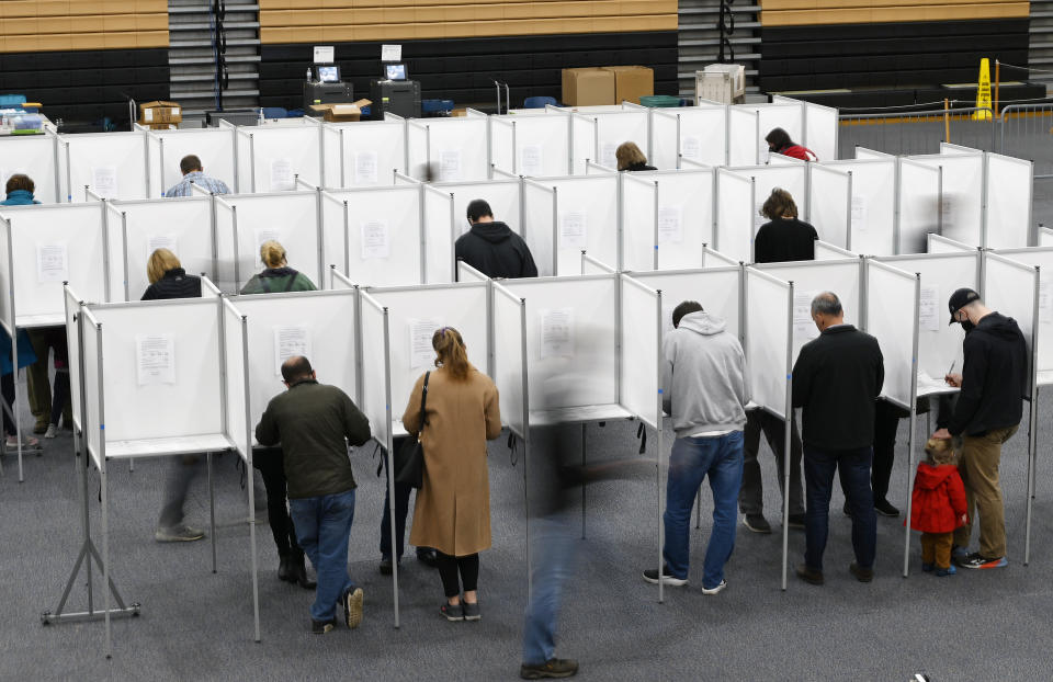 Voters fill out their ballots in the voting booths at Scarborough High School in Portland, Maine, on Nov. 2.