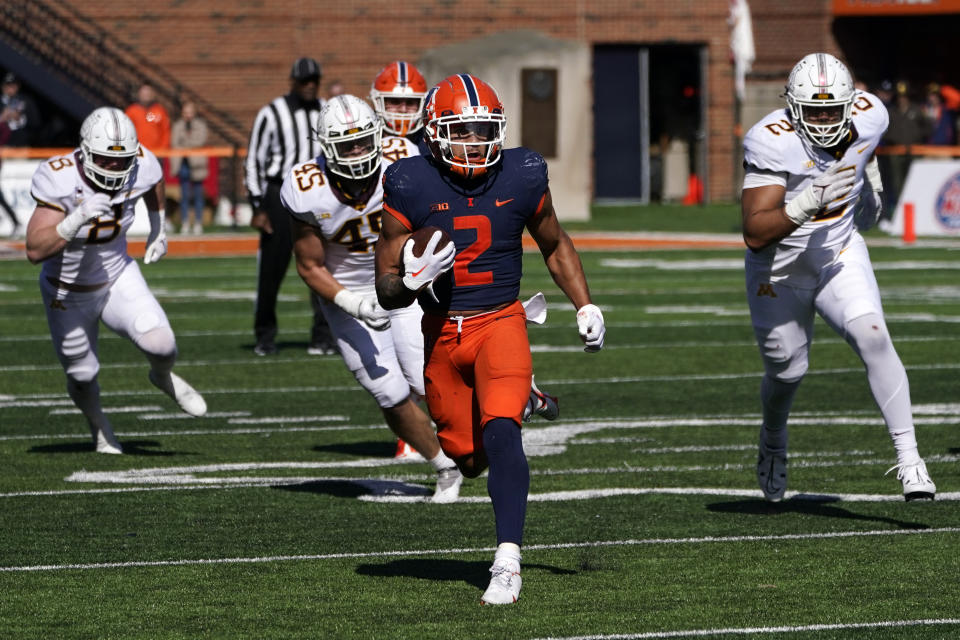 Illinois running back Chase Brown carries the ball during the second half of an NCAA college football game against Minnesota, Saturday, Oct. 15, 2022, in Champaign, Ill. (AP Photo/Charles Rex Arbogast)