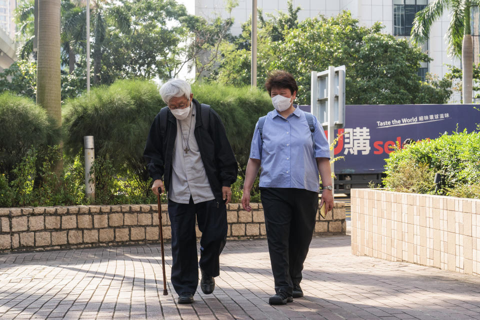 Cardinal Joseph Zen, left, arrives at the West Kowloon Magistrates' courts in Hong Kong on Monday, Sept. 26, 2022. The 90-year-old Catholic cardinal and five others stood trial in Hong Kong on Monday for allegedly failing to register a now-defunct fund set up to assist people arrested in the mass anti-government protests in the city three years ago. (AP Photo/Oiyan Chan)