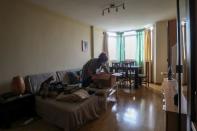 Ines Alcolea unpacks moving boxes in her new rented apartment in Fuensalida