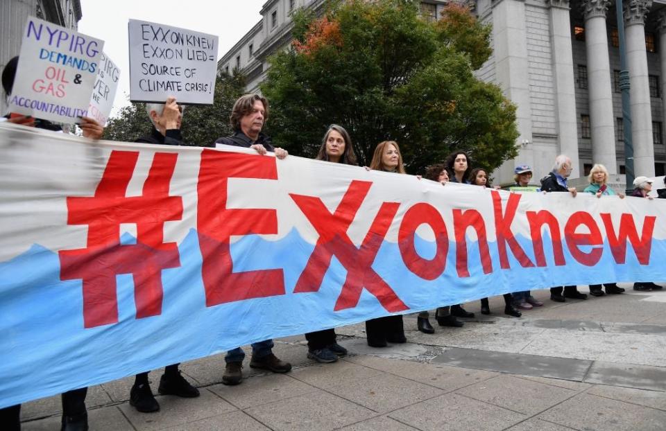 Climate activists protest on the first day of the ExxonMobil trial outside the New York State Supreme Court in October 2019. New legislation has been introduced that would make fossil fuel corporations responsible for the emissions they produce (AFP via Getty)