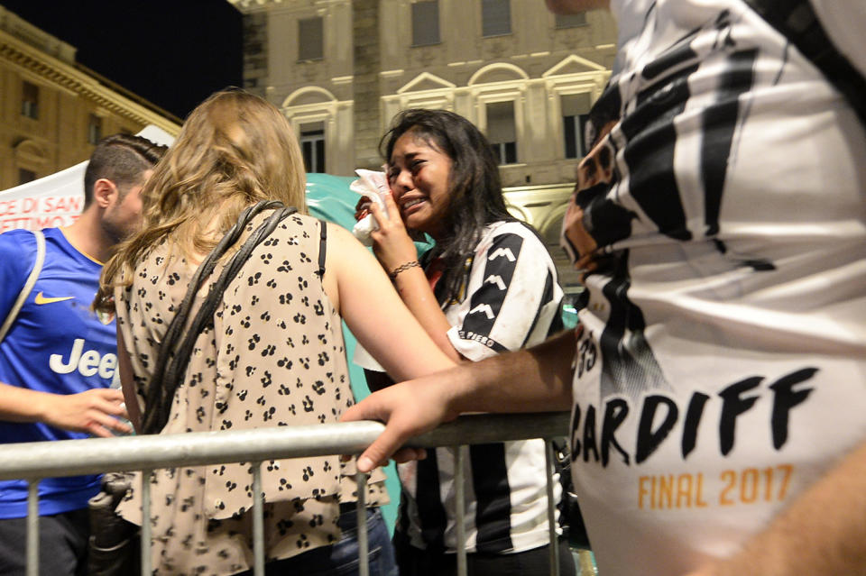 <p>An injured woman cries at Piazza San Carlo after a panic movement in the fanzone where thousands of Juventus fans were watching the UEFA Champions League Final football match between Juventus and Real Madrid on a giant screen, on June 3, 2017 in Turin. (Massimo Pinca/AFP/Getty Images) </p>