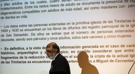 Forensic archaeologist Francisco Etxeberria walks past a projection of the conclusions about the search for Spanish writer Miguel de Cervantes' remains, in Madrid March 17, 2015. REUTERS/Andrea Comas