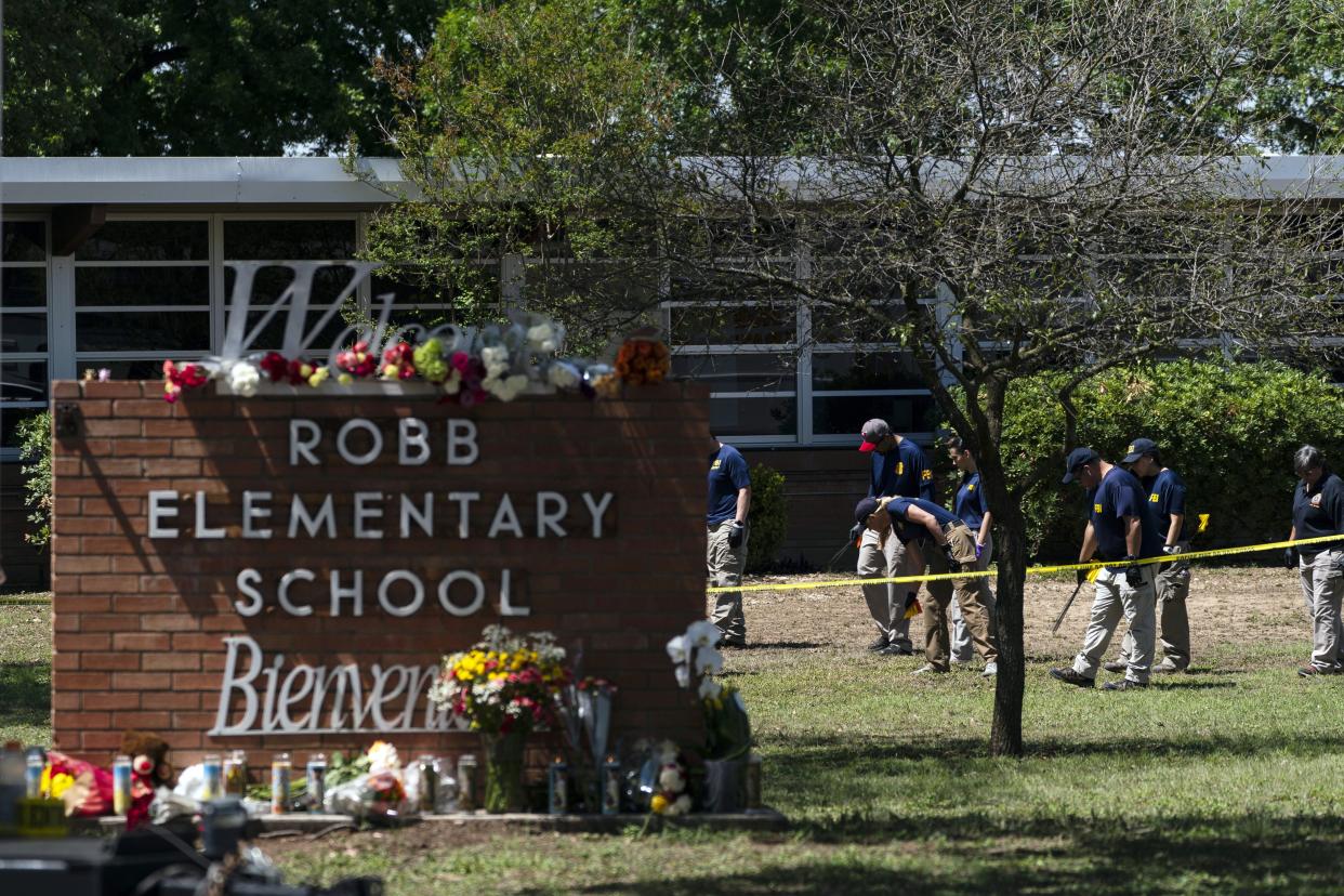 Investigators search for evidence outside Robb Elementary School on May 25, the day after an 18-year-old gunman attacked the school.