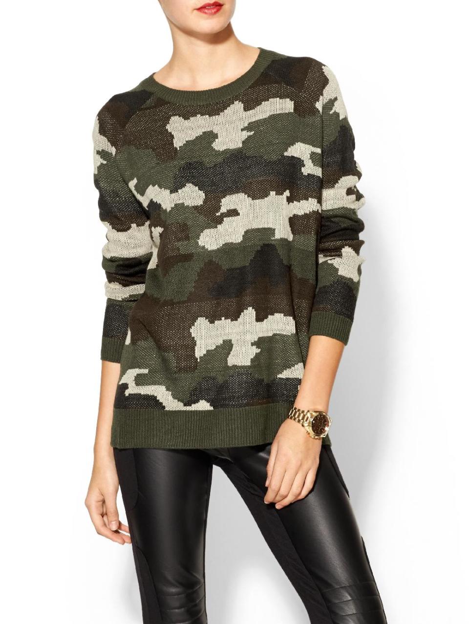 This product image released by Piperlime shows a camouflage sweater. The print that at one time was only a tool for military troops to go unnoticed has become a front-and-center look in fashion. It’s been adapted in luxe fur, sequin sweaters, athletic wear and casual kicks. (AP Photo/Piperlime)