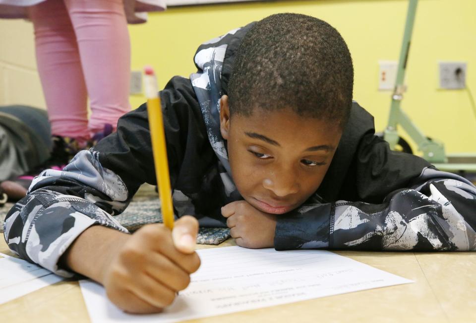 Fifth grader Chance Bivins works on a classroom assignment in Sara Wilkerson's classroom at Helen Arnold Community Learning Center in Akron. Chance is a family friend of Tyren Thompson. "I don't like guns," the 10-year-old says. "I don't like violence."