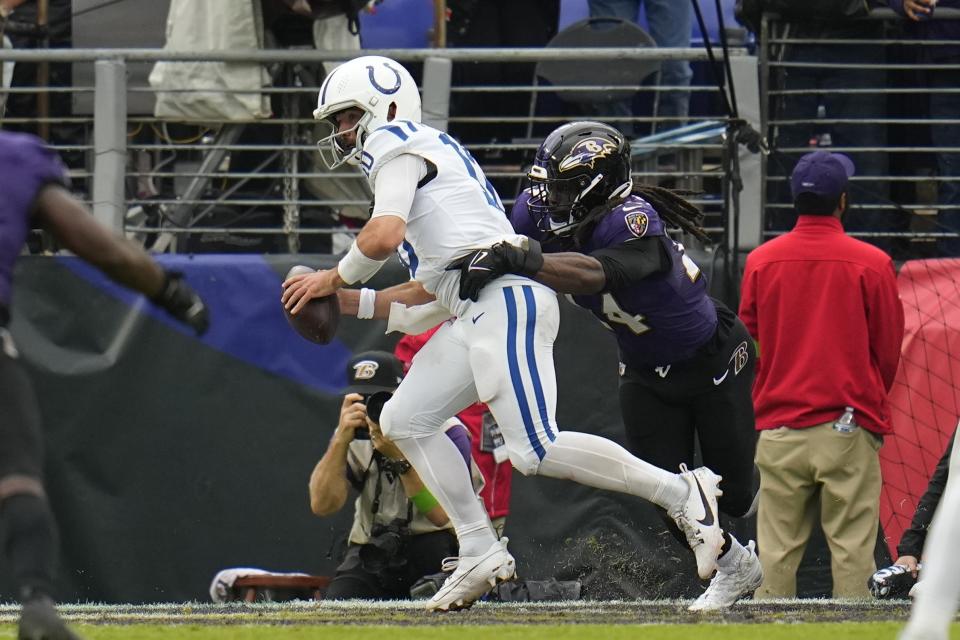 Baltimore Ravens' Jadeveon Clowney (24) hits Indianapolis Colts quarterback Gardner Minshew (10) in the end zone for a safety during the second half of an NFL football game, Sunday, Sept. 24, 2023, in Baltimore. (AP Photo/Julio Cortez)