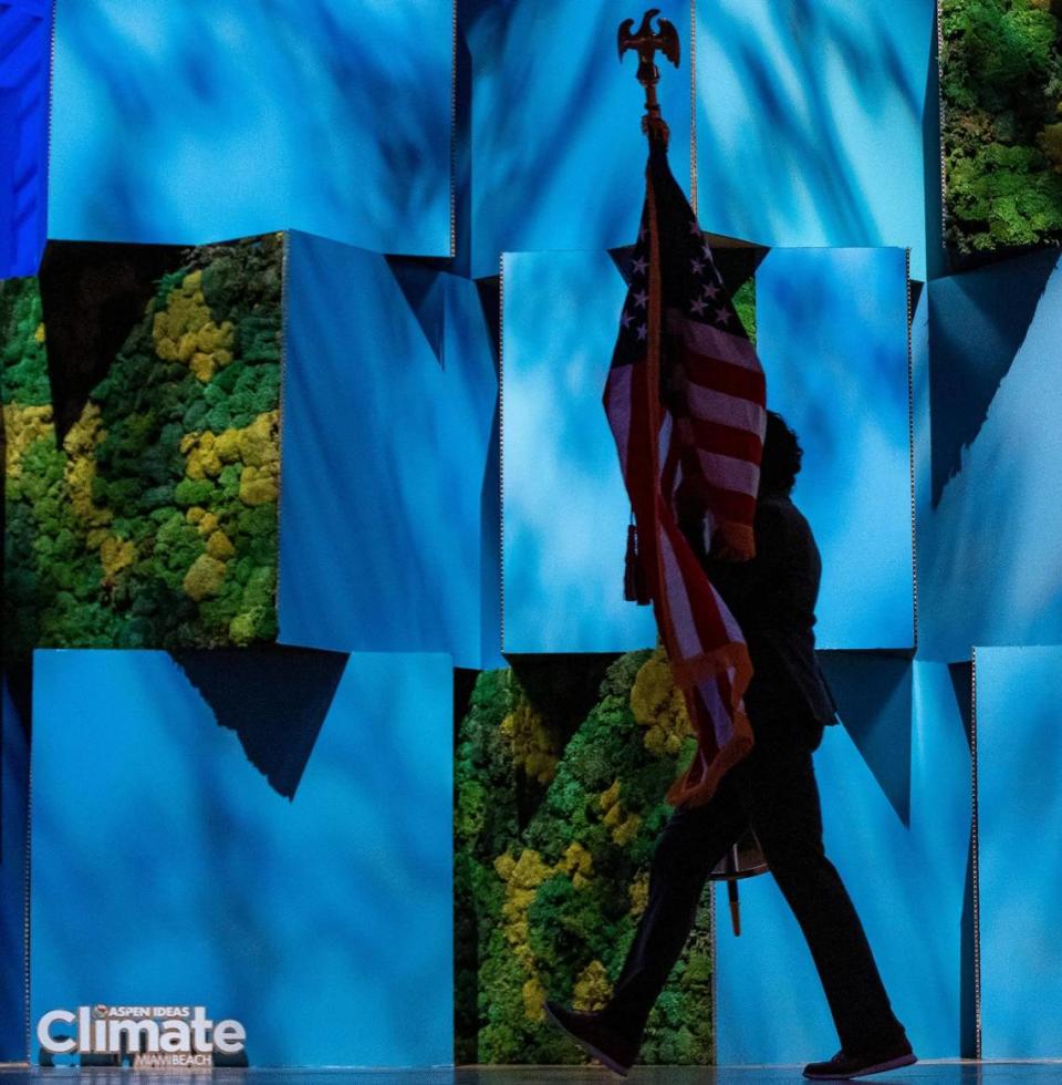 Un miembro del personal porta la bandera estadounidense antes del inicio de una conversación entre Gloria Estefan y la vicepresidenta Kamala Harris durante la conferencia Aspen Ideas: Climate, en el New World Center, el miércoles 8 de marzo de 2023, en Miami Beach, Florida.