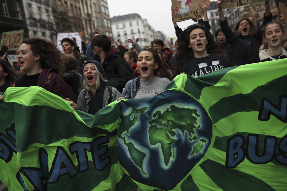 Youths shout slogans as they march during a climate protest in Brussels, Thursday, Feb. 28, 2019. It was the eighth week in a row that school students skipped school to protest, with one march of about 3,000 in Antwerp and a few thousand in Brussels and other provincial centers. (AP Photo/Francisco Seco)