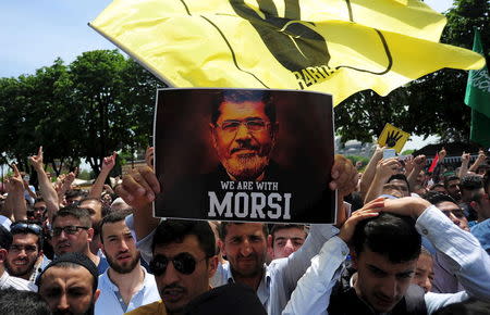 Pro-Islamist demonstrators hold a poster of former Egyptian President Mohamed Mursi during a rally in support of him in front of the Haghia Sophia museum at Sultanahmet square in Istanbul, Turkey, May 24, 2015. REUTERS/Yagiz Karahan/Files