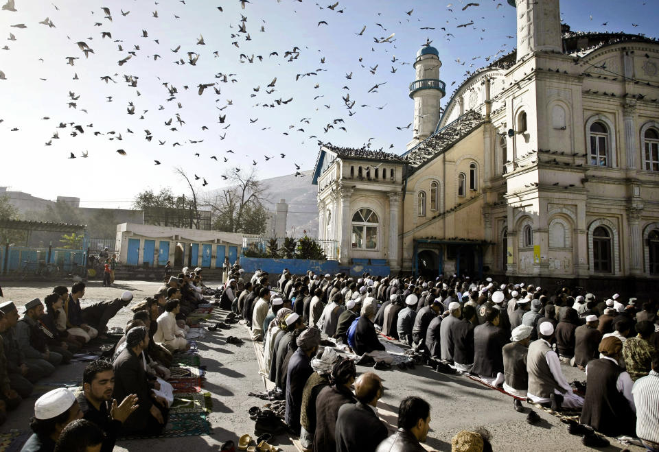 FILE - In this Friday, Oct. 26, 2012 file photo, Afghans listen to preacher while offering the Eid al Adha's prayers outside of Shah-e-Dushamshera mosque in Kabul, Afghanistan. As the country braces for next year's presidential election and the planned withdrawal of most foreign combat troops by the end of 2014, the panel urges the U.S. government and its allies to work harder to promote religious rights in the war-torn nation. (AP Photo/Musadeq Sadeq, File)