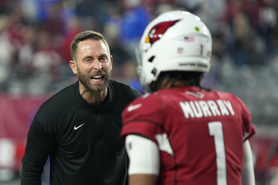 Arizona Cardinals head coach Kliff Kingsbury shouts instructions to his players, including Cardinals quarterback Kyler Murray (1), as they warm up prior to an NFL football game against the Los Angeles Rams Monday, Dec. 13, 2021, in Glendale, Ariz. (AP Photo/Rick Scuteri)