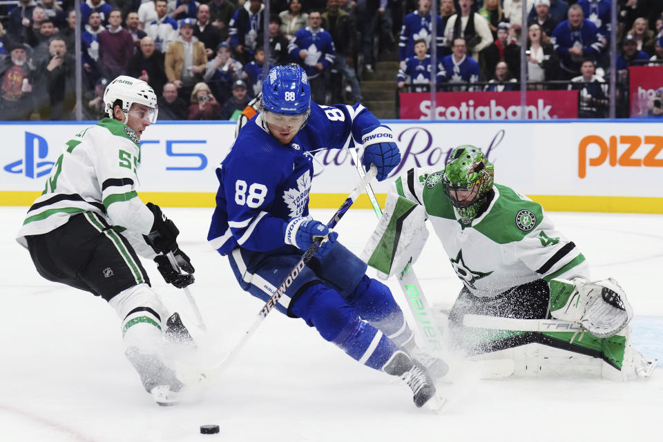 Dallas Stars goaltender Scott Wedgewood (41) stops Toronto Maple Leafs forward William Nylander (88) as Stars defenseman Thomas Harley (55) watches during the second period of an NHL hockey game Wednesday, Feb. 7, 2024, in Toronto. (Nathan Denette/The Canadian Press via AP)