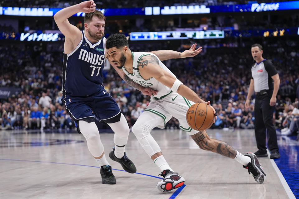 Boston Celtics forward Jayson Tatum, drives against Dallas Mavericks guard Luka Doncic during the second half in Game 3 of the NBA basketball finals, Wednesday, June 12, 2024, in Dallas. (AP Photo/Tony Gutierrez)