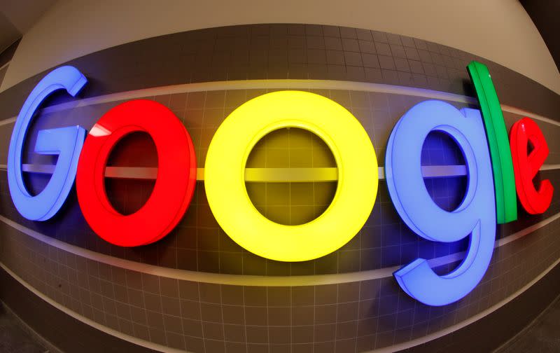 An illuminated Google logo inside an office building in Zurich