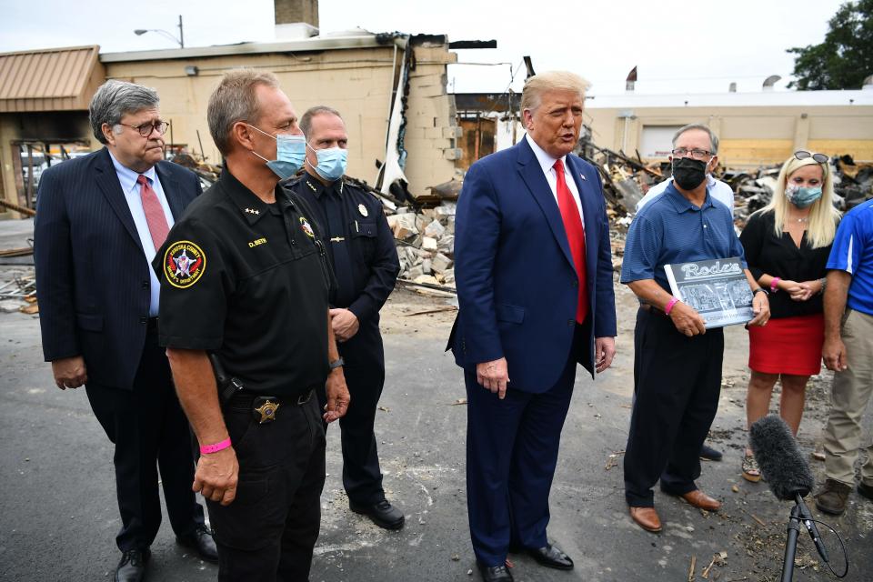 President Donald Trump and Attorney General William Barr tour an area affected by civil unrest in Kenosha, Wis., on Sept. 1.